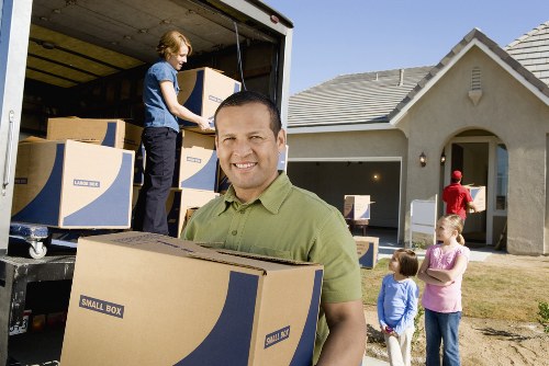 Packed moving boxes and furniture in a central London flat